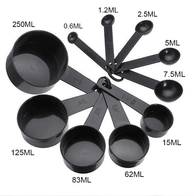 Black 10-piece plastic measuring spoons set on kitchen counter