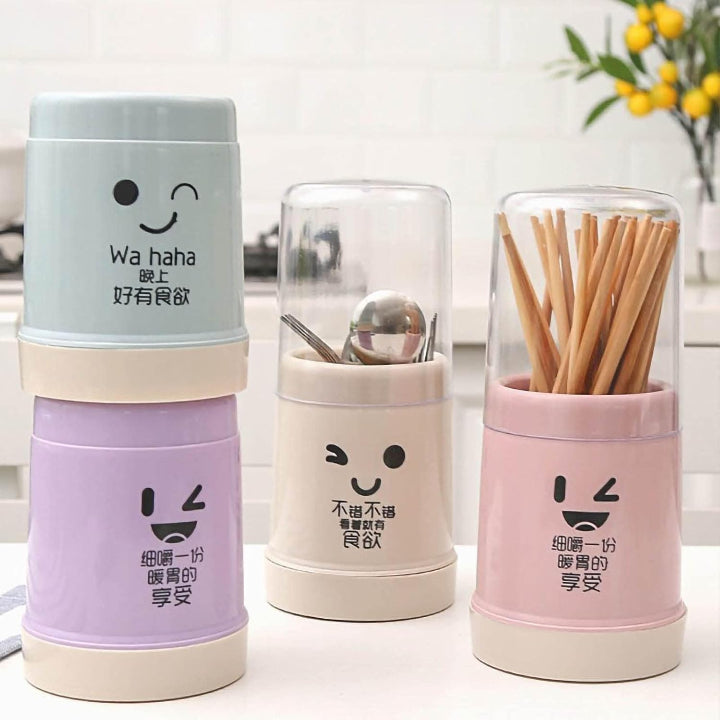 Three colorful containers with cartoon faces and utensils on a white background