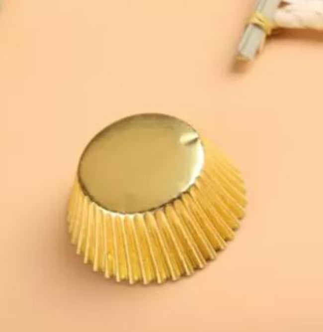 Stack of 100 pieces of gold or silver thickened aluminum foil disposable cupcake liners and muffin cups, ready for professional baking
