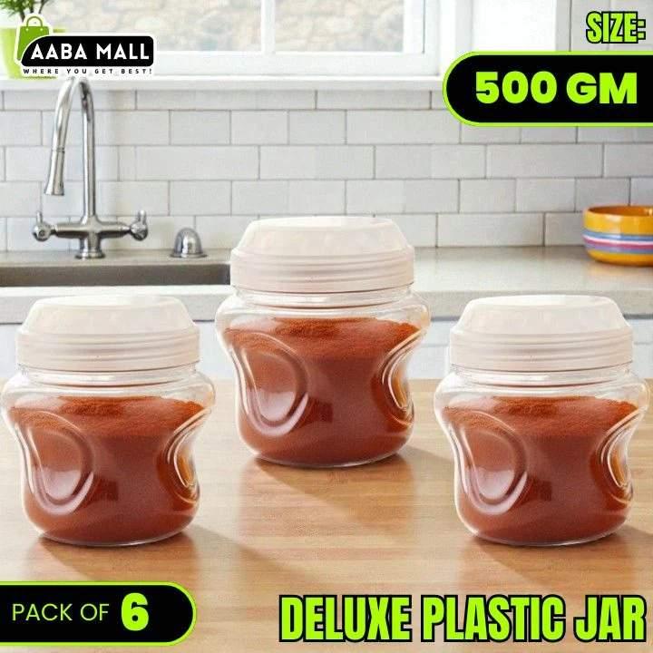 Three plastic jars with tomato sauce on a kitchen counter, labeled 'Pack of 6' and '500 GM'.