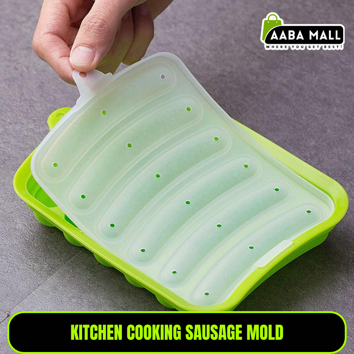 Green kitchen cooking sausage mold with a hand lifting the lid on a gray background, branded 'AABA MALL'.