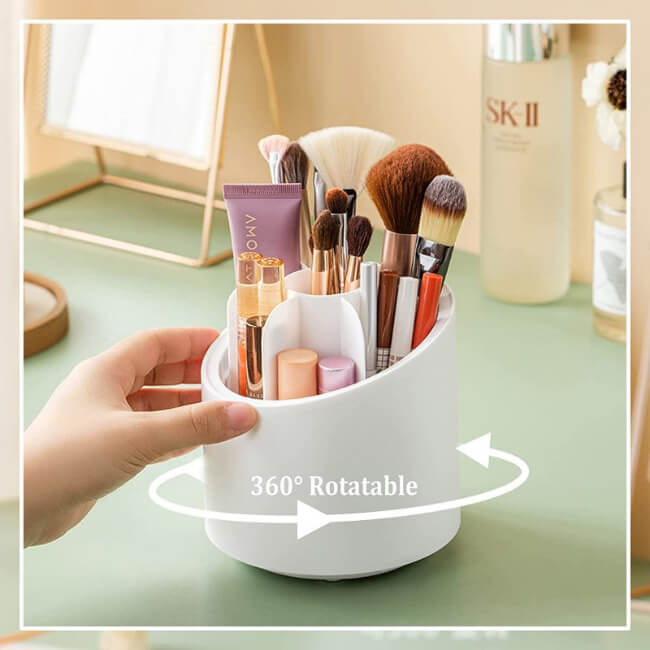 White makeup brush holder with various brushes and products on a light green surface, labeled '360° Rotatable'.