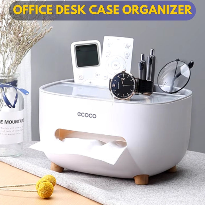 A white Ecoco multifunctional tissue storage box on an office desk, organizing various items such as a phone, remote control, and glasses. The box has a removable double-layer design and a non-slip base.