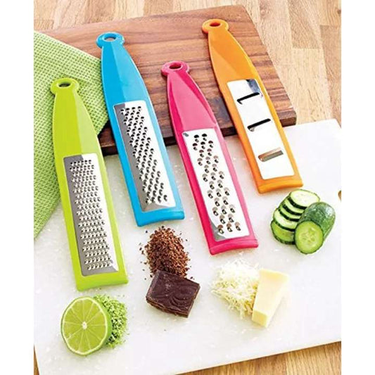 Colorful kitchen graters on a cutting board with vegetables and cheese.