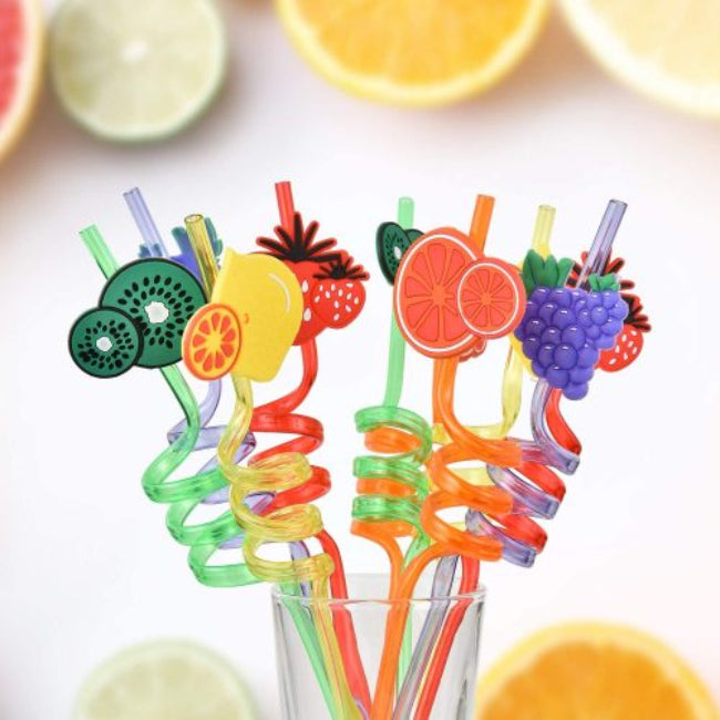Pack of 4 reusable plastic drinking straws with colorful molded fruit tops (e.g., pineapple, strawberry), shown decorating glasses of brightly colored juice at a kids' birthday party.