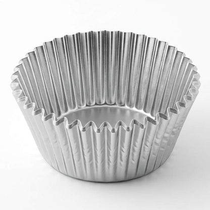 Metallic muffin tin on a white background