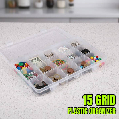 Clear plastic organizer with compartments filled with various small items on a countertop.