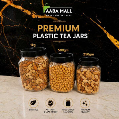 Three clear plastic tea jars with black lids, filled with assorted nuts and dried fruits, displayed on a marble surface against a black marble background. Text at the top reads 'AABA MALL PREMIUM PLASTIC TEA JARS' with weights 1kg, 500gm, and 250gm, and feature icons for BPA free, air tight & leak proof, food grade material, and premium quality.