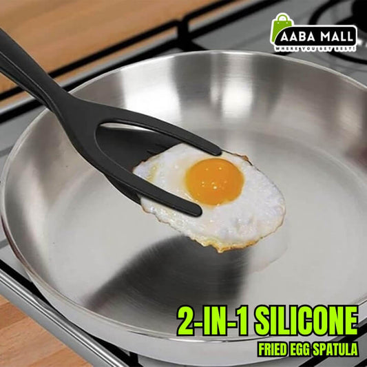 2-in-1 silicone fried egg spatula lifting a fried egg from a pan on a stove.