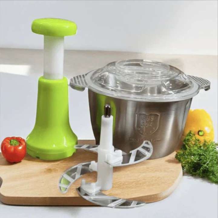 Kitchen tool with green handle and metal container on a wooden cutting board.