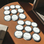 Multiple small containers with labels on a wooden surface