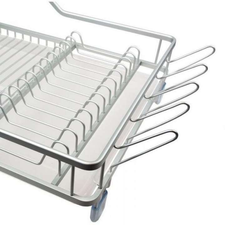 Metal dish rack with cutlery on a white background