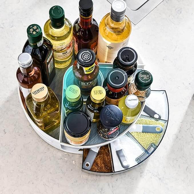 Rotating spice rack with various bottles on a light surface