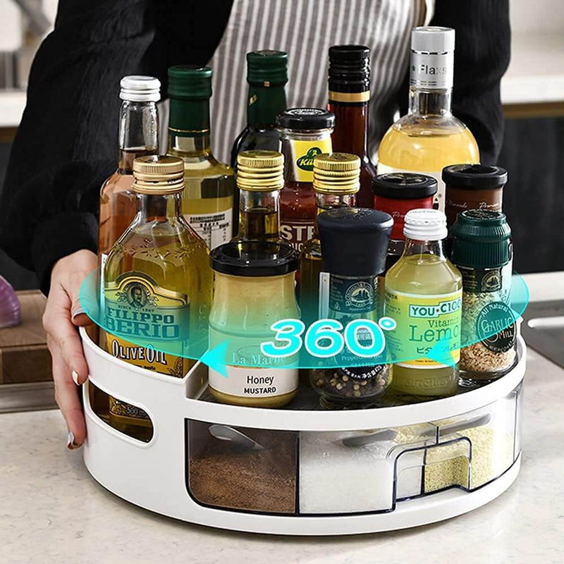 Rotating spice rack with various bottles and containers on a kitchen counter.