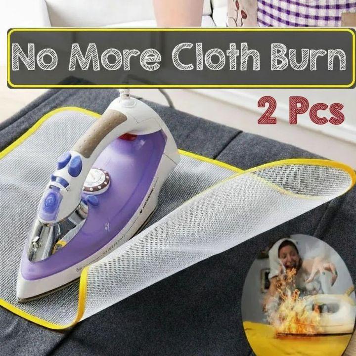 A purple and white iron with a yellow-trimmed mesh protector sheet laid over dark gray fabric. Large text reads 'No More Cloth Burn' and '2 Pcs,' with a small circular inset showing a person reacting to a burning cloth.