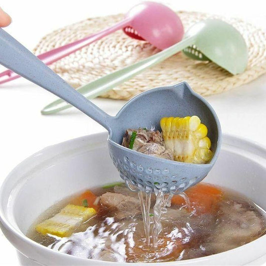 A gray silicone ladle with a long handle is shown lifting soup and vegetables from a white pot. Two additional ladles in pink and light green rest on a woven placemat in the background.