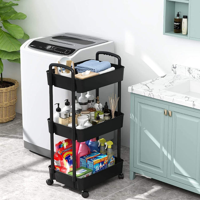 White 3-tier plastic rolling utility cart with handle, featuring 360-degree rotating wheels, holding vegetables and kitchen essentials.