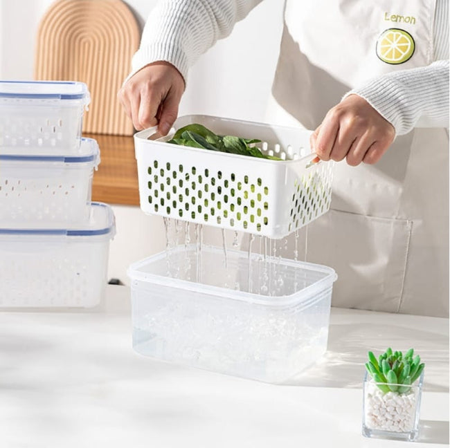 Set of three stackable fridge storage containers with green, blue, and clear lids, showing inner detachable drain basket with fresh berries and vegetables.