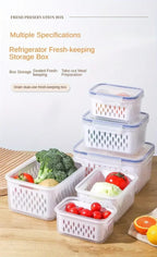 Set of three stackable fridge storage containers with green, blue, and clear lids, showing inner detachable drain basket with fresh berries and vegetables.