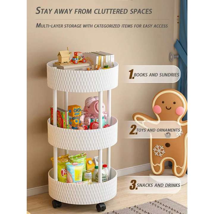 A three-tier white wicker-style rolling storage cart with black caster wheels, shown in a room setting with books, toys, and snacks on its shelves. Text overlays describe storage categories, and a gingerbread person-shaped cabinet stands to the right.