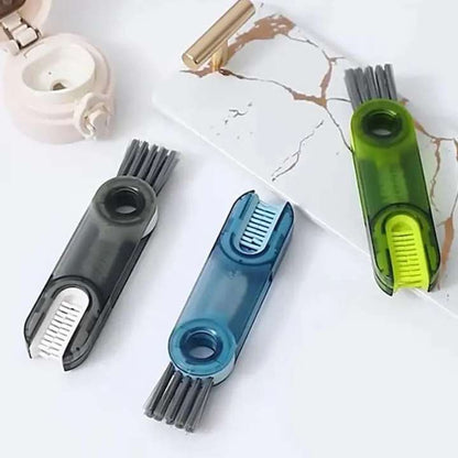 Three cleaning tools with brush and scrubber heads on a marble surface