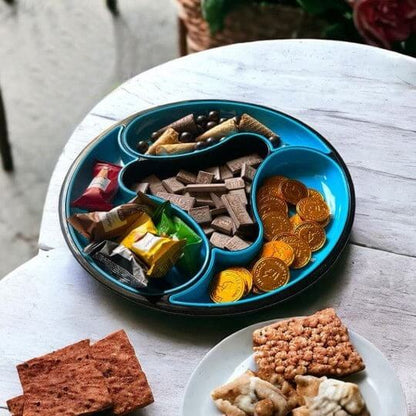 Blue divided plate with snacks on a white table