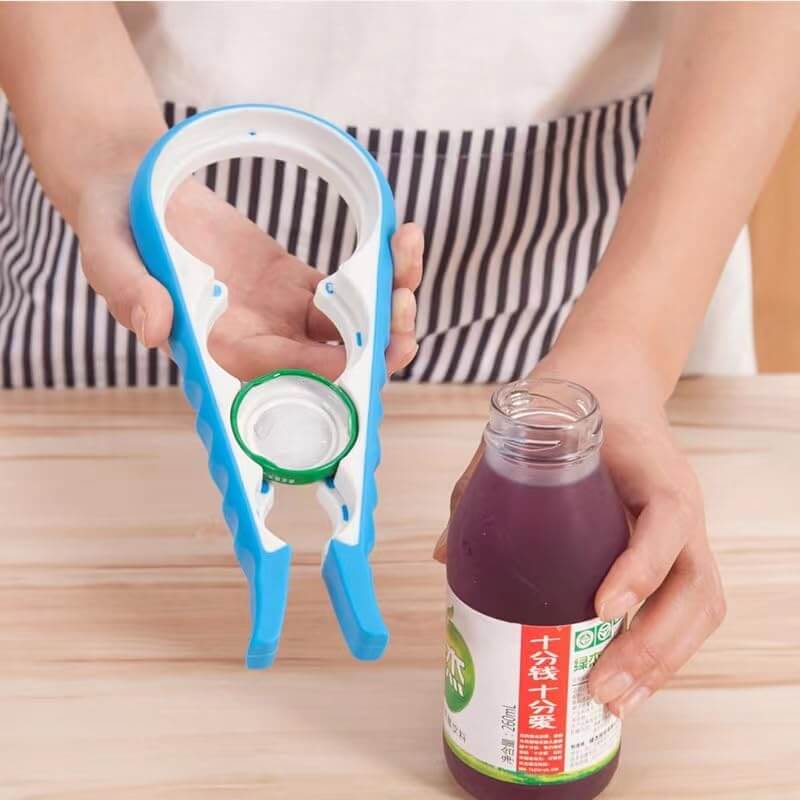 Person using a bottle cap removal tool on a bottle with a striped apron in the background