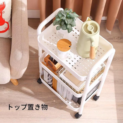 White storage cart with items on a wooden floor next to a beige couch.