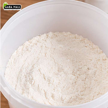 A close-up of white flour piled inside a large white plastic tub, with a small AABA MALL logo in the top-left corner.