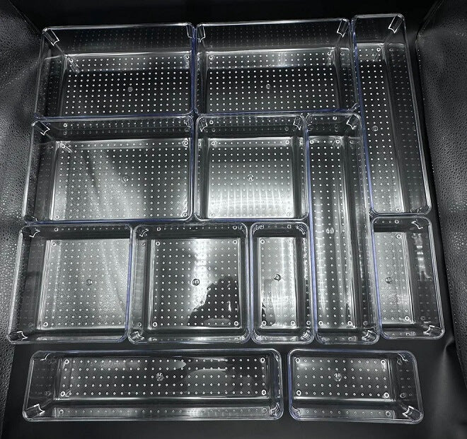 Set of clear plastic trays with grid patterns on a black background