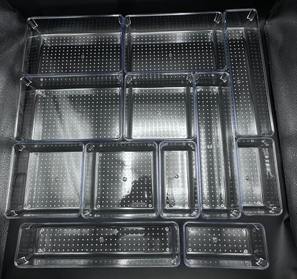 Set of clear plastic trays with grid patterns on a black background