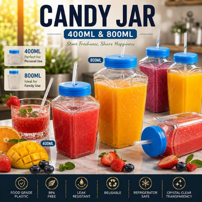 Candy Jar with blue lids containing colorful drinks on a table with fruits.