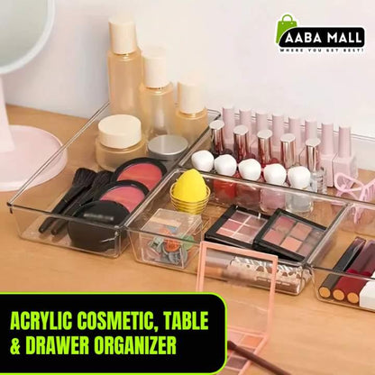 Acrylic cosmetic organizer with makeup items on a table, branded 'Aaba Mall'.
