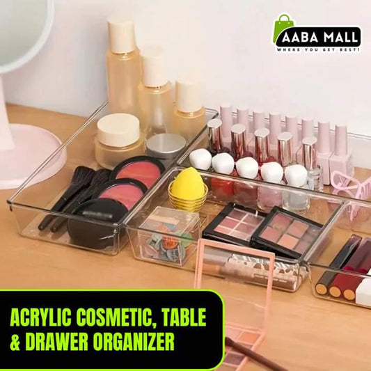 Acrylic cosmetic organizer with makeup items on a table, branded 'Aaba Mall'.
