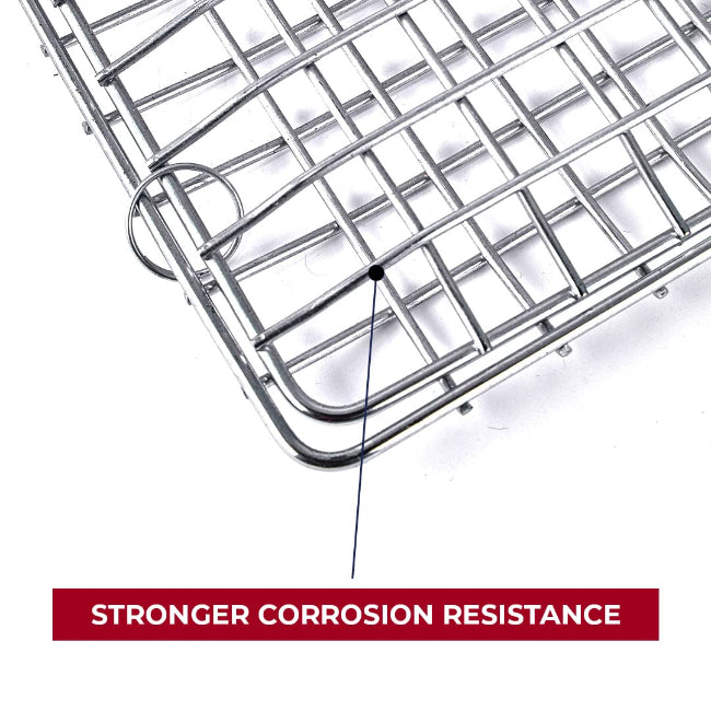 A non-stick metal BBQ grill basket with a long, light-colored wooden handle, shown closed and ready for grilling vegetables or fish.