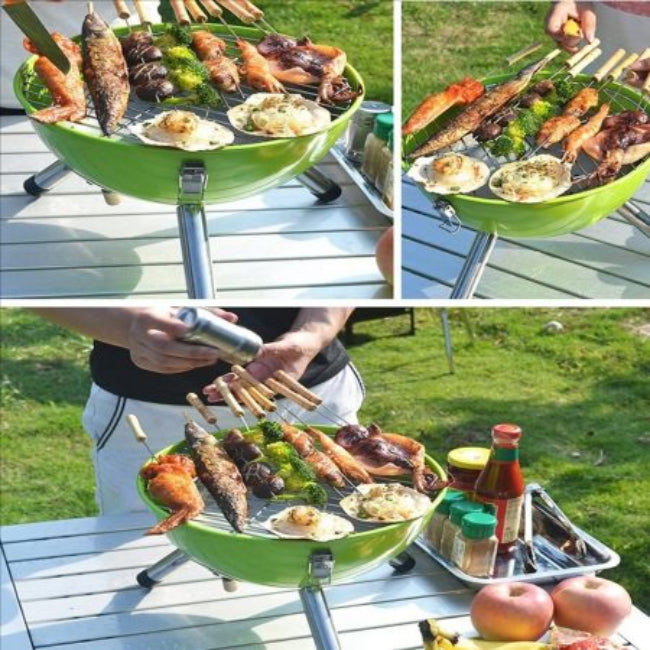 A compact, portable charcoal BBQ grill with a black football shape and a sturdy carrying handle, shown on an outdoor deck.