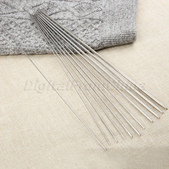 A close-up shot of a set of 6 flat, 17-inch stainless steel BBQ skewers resting on a wooden picnic table, suitable for shish kabobs and grilling.