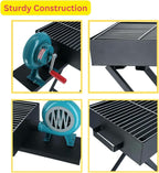 A black portable charcoal BBQ grill with a stand, showing the side-mounted manual hand-crank blower fan integrated into the unit.