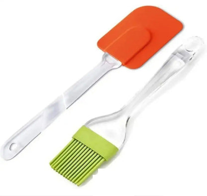 Set of 2 mini silicone kitchen tools (spatula and pastry brush) in blue, shown scraping the remnants of cake batter out of a small mixing bowl, illustrating the compact size.