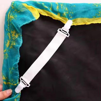 White strap with a clip attached to a blue and yellow fabric