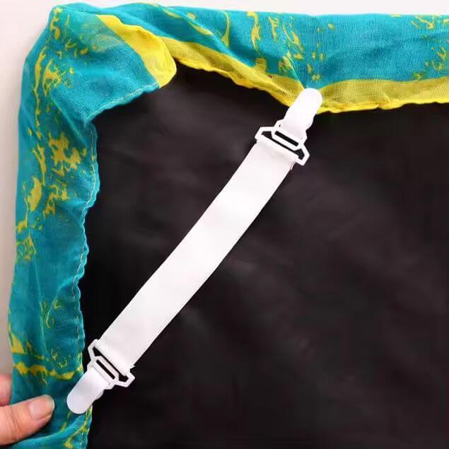 White strap with a clip attached to a blue and yellow fabric