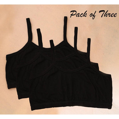 Pack of three black crop tops on a beige background