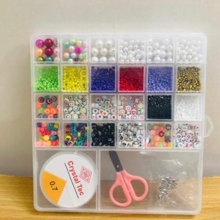 Clear organizer with beads and tools on a wooden surface AABA MALL 