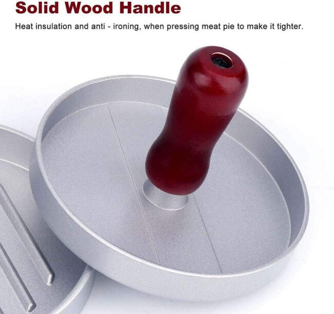 Metallic pie press with a red wooden handle on a white background