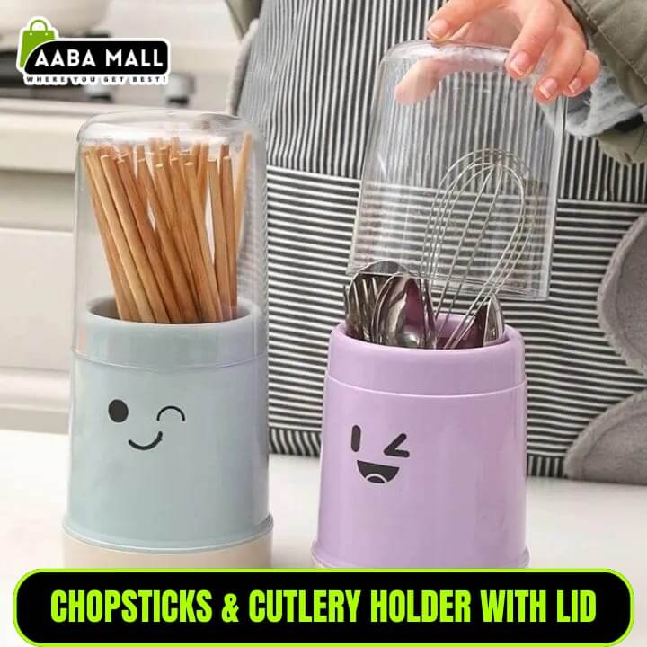 Two containers with smiley face designs, one holding chopsticks and the other cutlery, on a kitchen counter.
