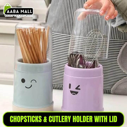 Two containers with smiley face designs, one holding chopsticks and the other cutlery, on a kitchen counter.