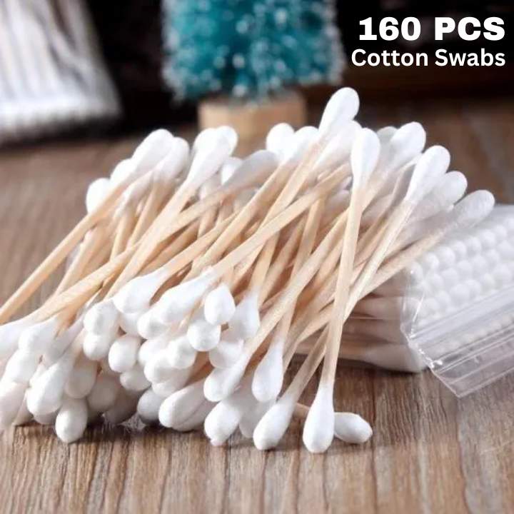 160 pcs cotton swabs on a wooden surface with packaging.