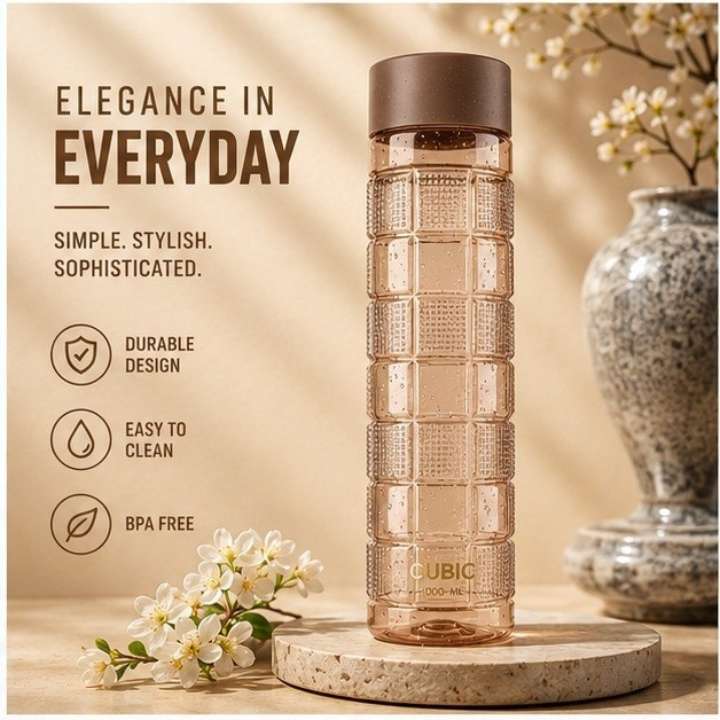 Transparent water bottle with brown lid on a wooden surface with decorative elements.
