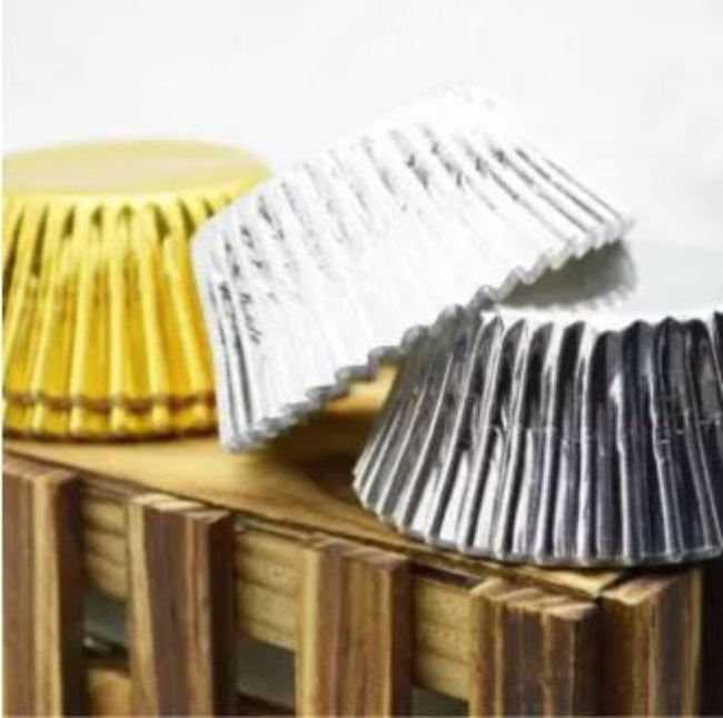 Stack of 100 pieces of gold or silver thickened aluminum foil disposable cupcake liners and muffin cups, ready for professional baking