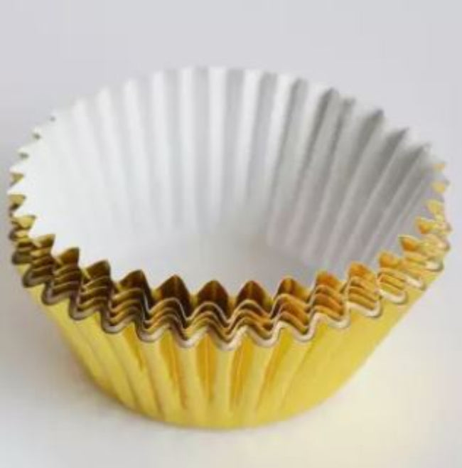 Stack of 100 pieces of gold or silver thickened aluminum foil disposable cupcake liners and muffin cups, ready for professional baking